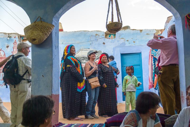 ethnic-nubian-women-courtyard-typical-house-blue
